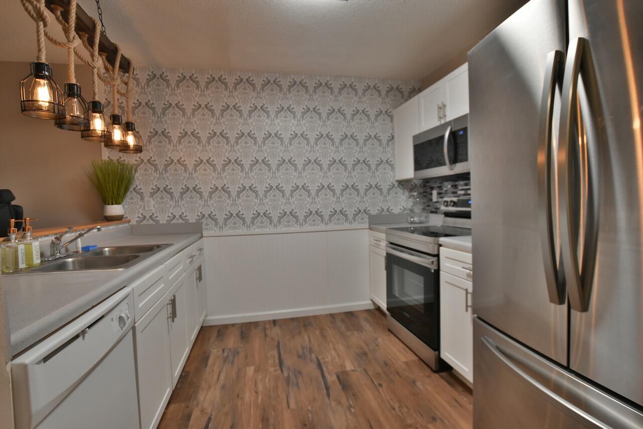 505 Keystone Road Mary Esther, FL 32569 - Photo 3 of 13 a kitchen with stainless steel appliances a refrigerator sink and stove