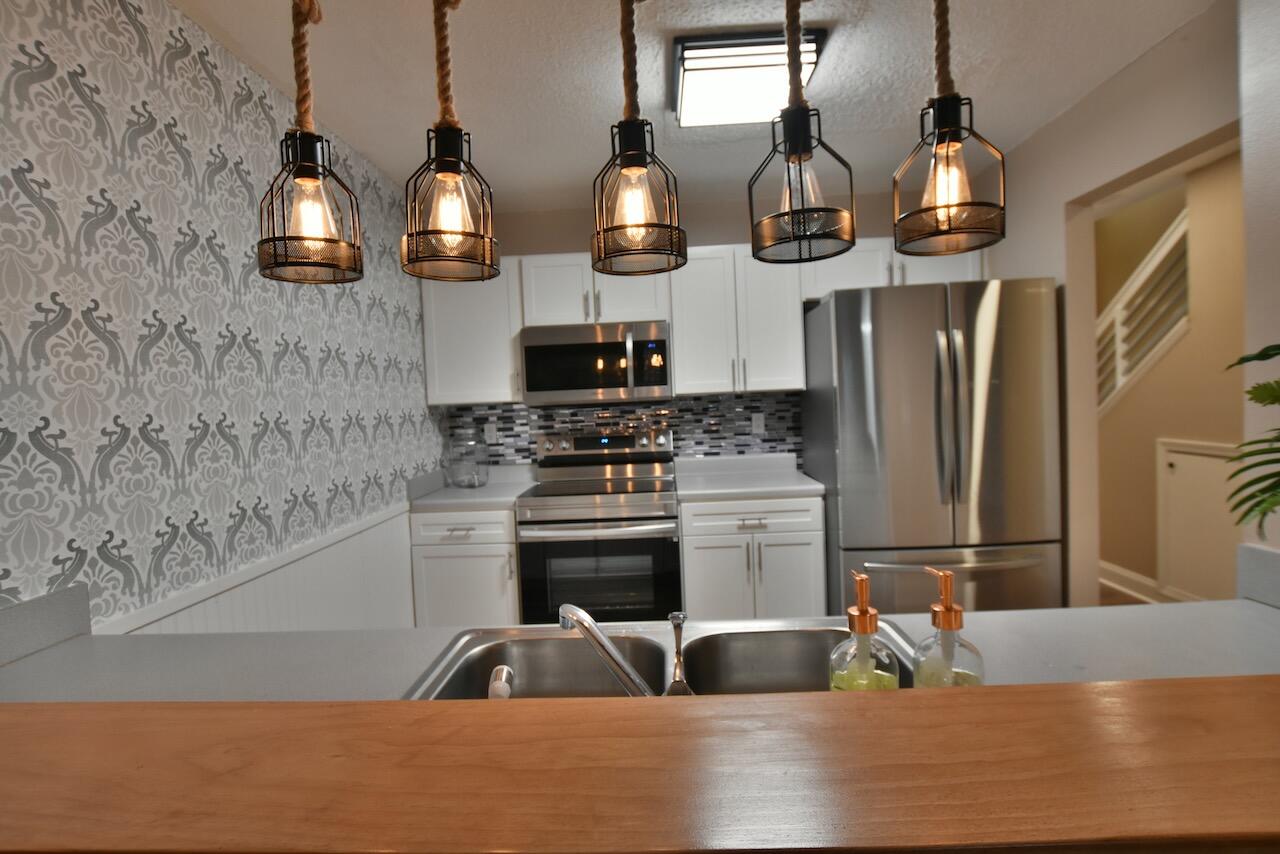 505 Keystone Road Mary Esther, FL 32569 - Photo 4 of 13 a kitchen with stainless steel appliances granite countertop a sink a stove and a refrigerator