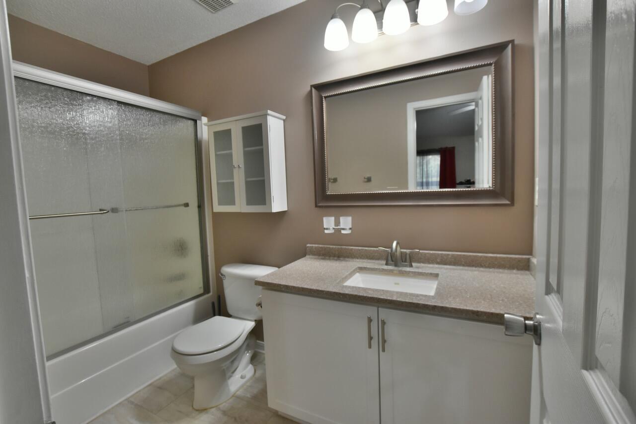 505 Keystone Road Mary Esther, FL 32569 - Photo 10 of 13 a bathroom with a sink toilet and shower
