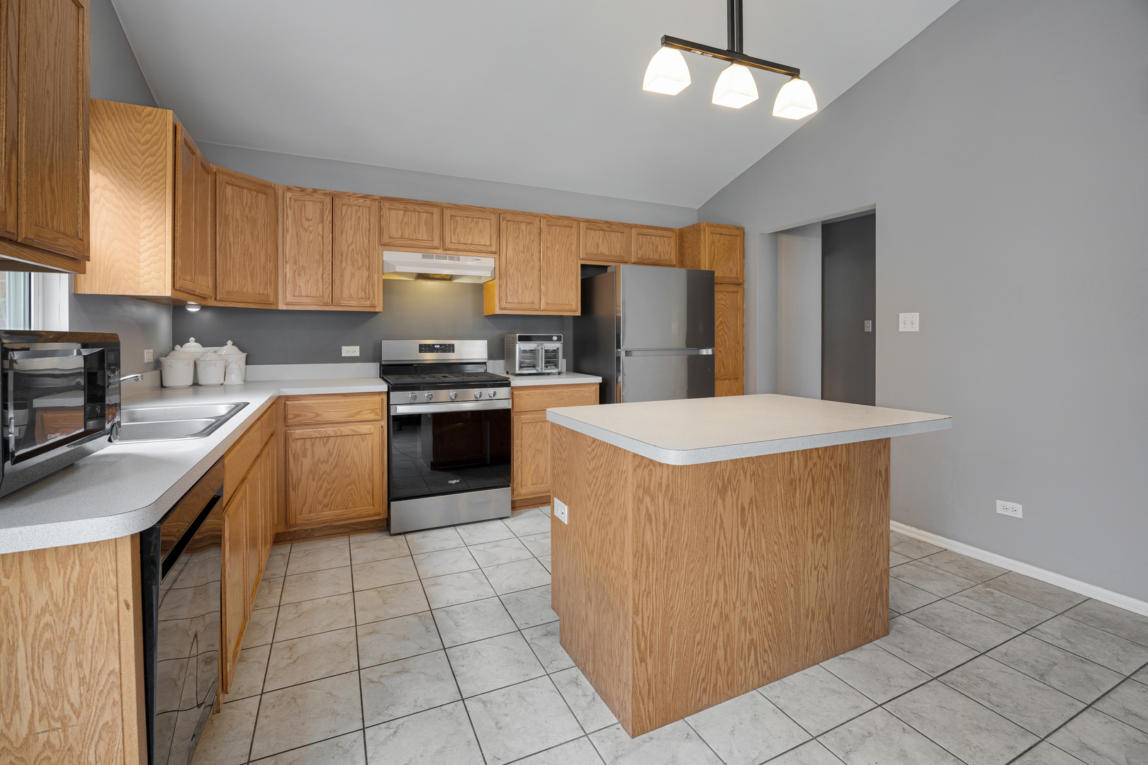 1014 Edinburgh Court Joliet, IL 60431 - Photo 4 of 25 a kitchen with stainless steel appliances granite countertop a stove top oven a sink a counter top space and cabinets
