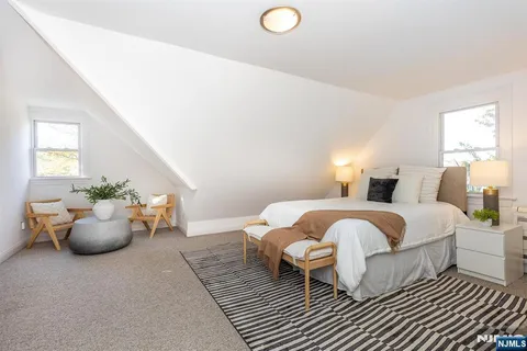 a spacious bedroom with a bed and window