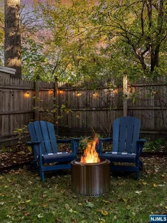a view of a backyard with sitting area furniture and wooden fence