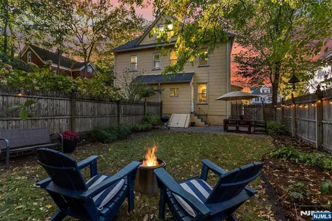 a view of a backyard with couches table and chairs