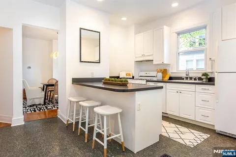 a kitchen with a sink cabinets and window