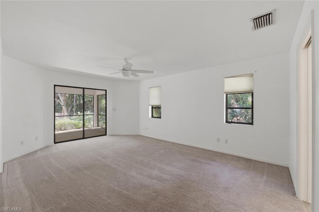 5356 Sycamore Drive Naples, FL 34119 - Photo 13 of 20 an empty room with windows and ceiling fan
