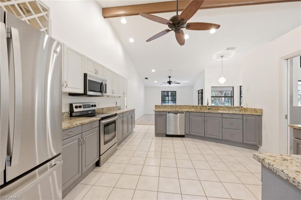 5356 Sycamore Drive Naples, FL 34119 - Photo 4 of 20 a kitchen with stainless steel appliances a sink cabinets and microwave