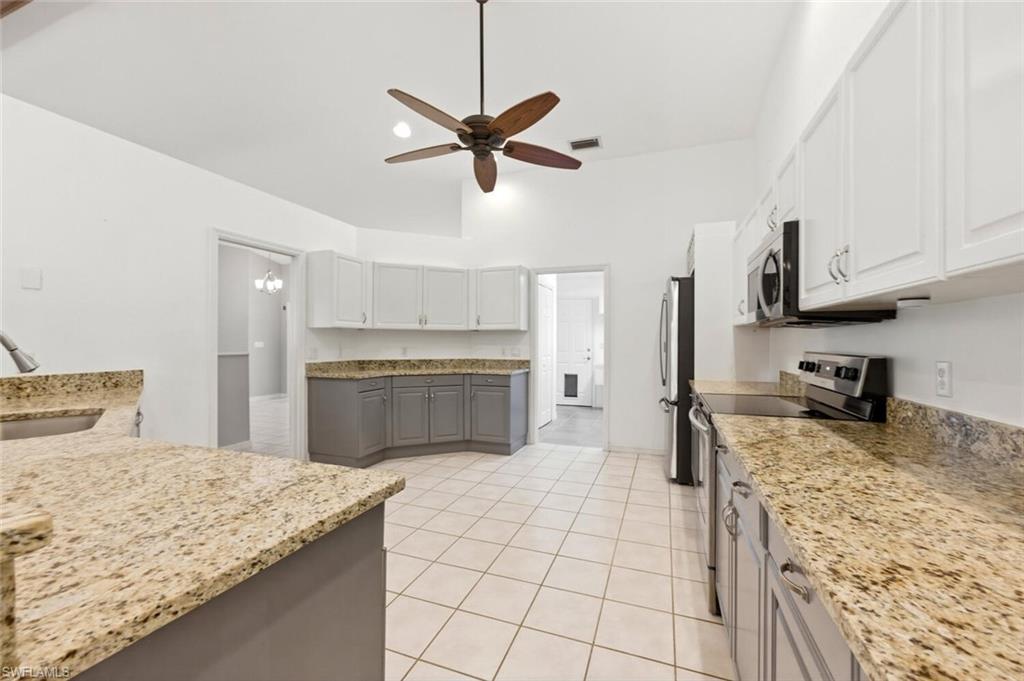 5356 Sycamore Drive Naples, FL 34119 - Photo 10 of 20 a kitchen with granite countertop a sink a counter top space appliances and cabinets