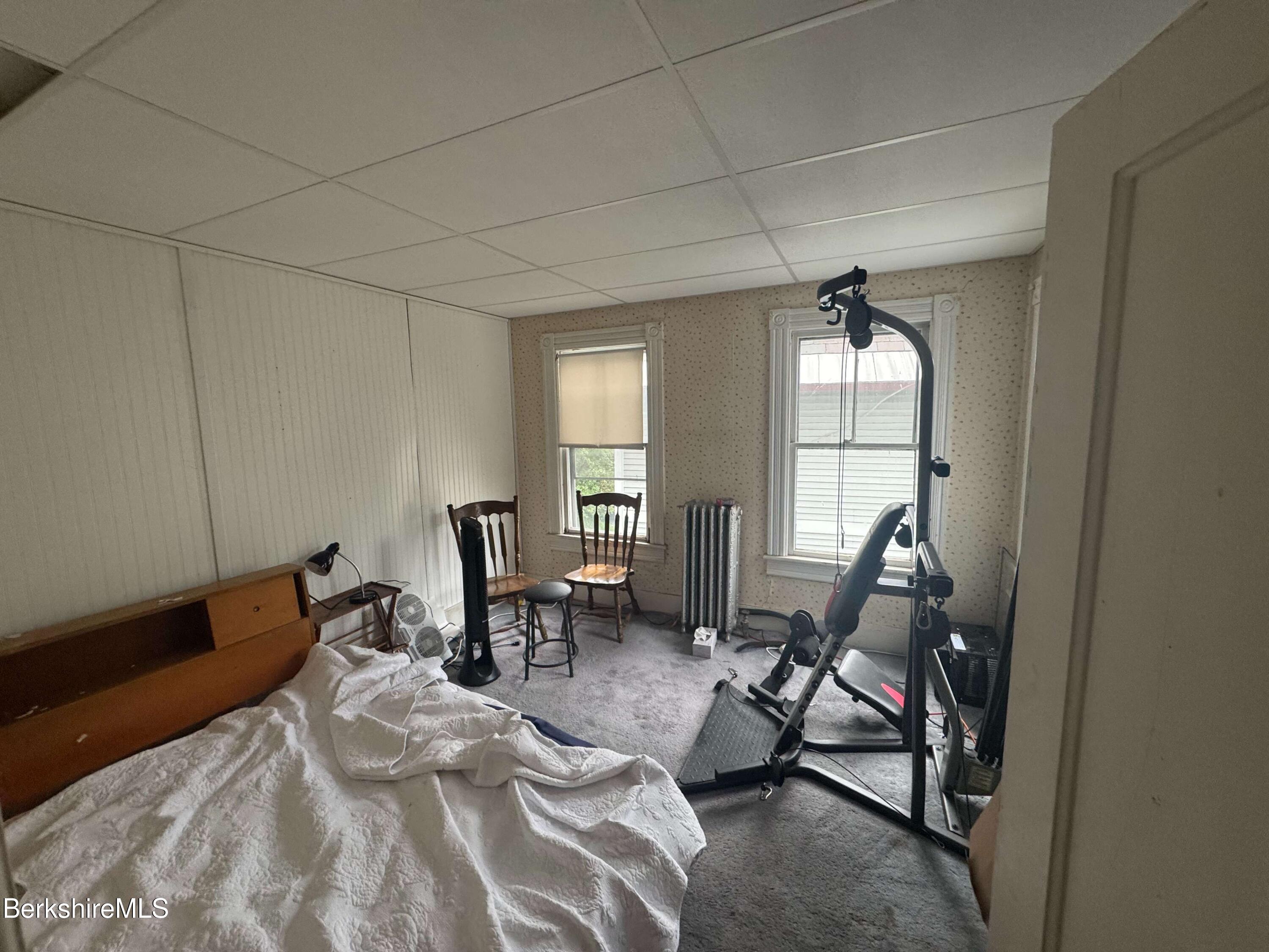 77 Front Street North Adams, MA 01247 - Photo 11 of 16 a bedroom with furniture and a window