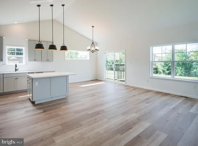 a kitchen with stainless steel appliances kitchen island granite countertop a sink a counter top space and cabinets
