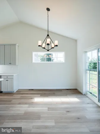 a kitchen with stainless steel appliances white cabinets a sink a stove a kitchen island and chairs