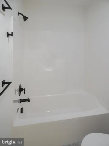 a view of house with garden and tall tress