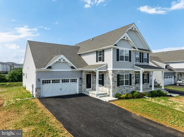 an aerial view of a residential houses with outdoor space