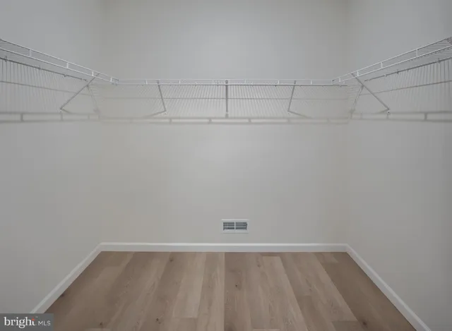 a view of a kitchen with a dishwasher and white cabinets