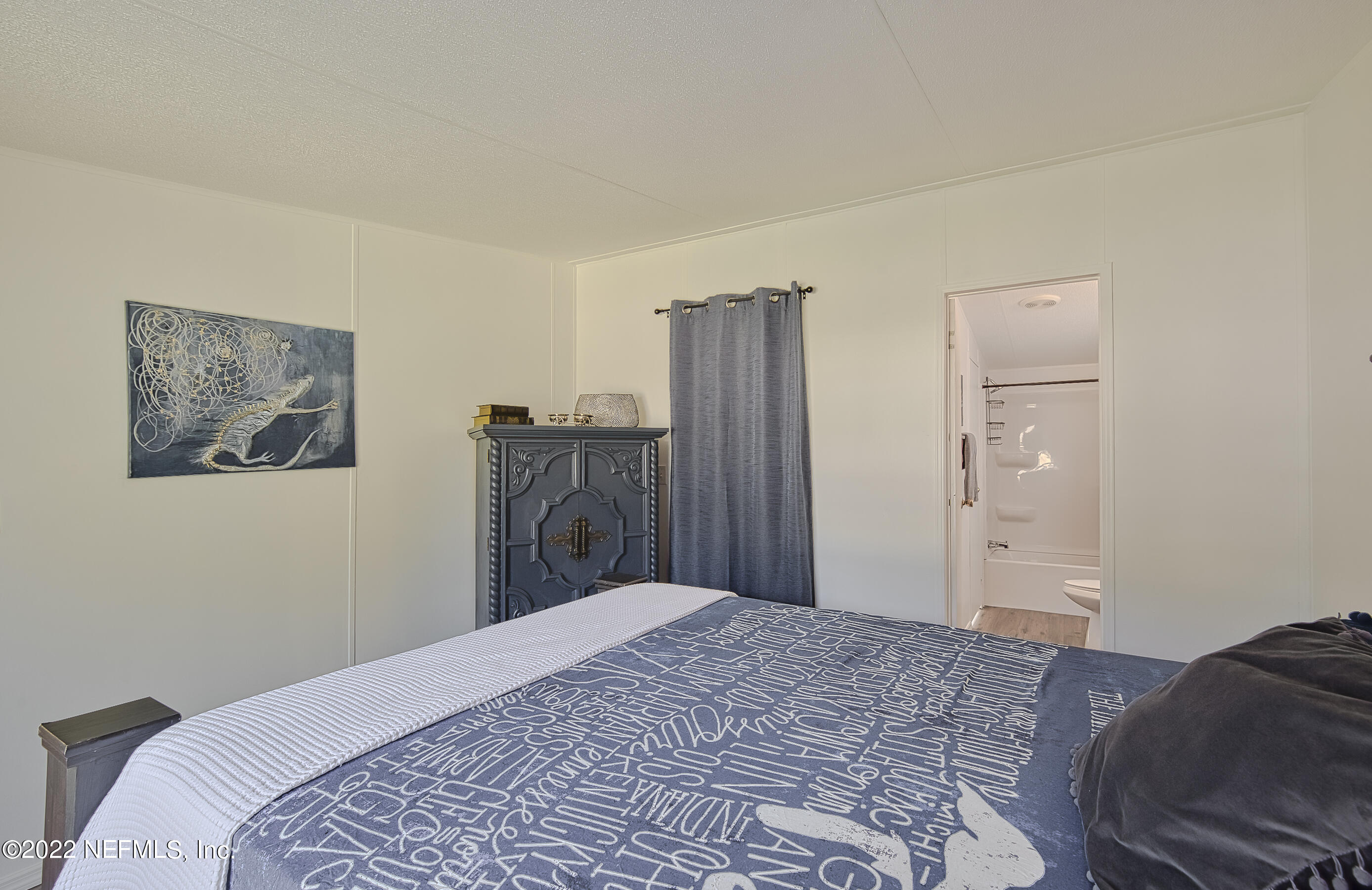 4509 De Leon Place St. Augustine, FL 32095 - Photo 15 of 35 a bedroom with a bed and a painting on the wall