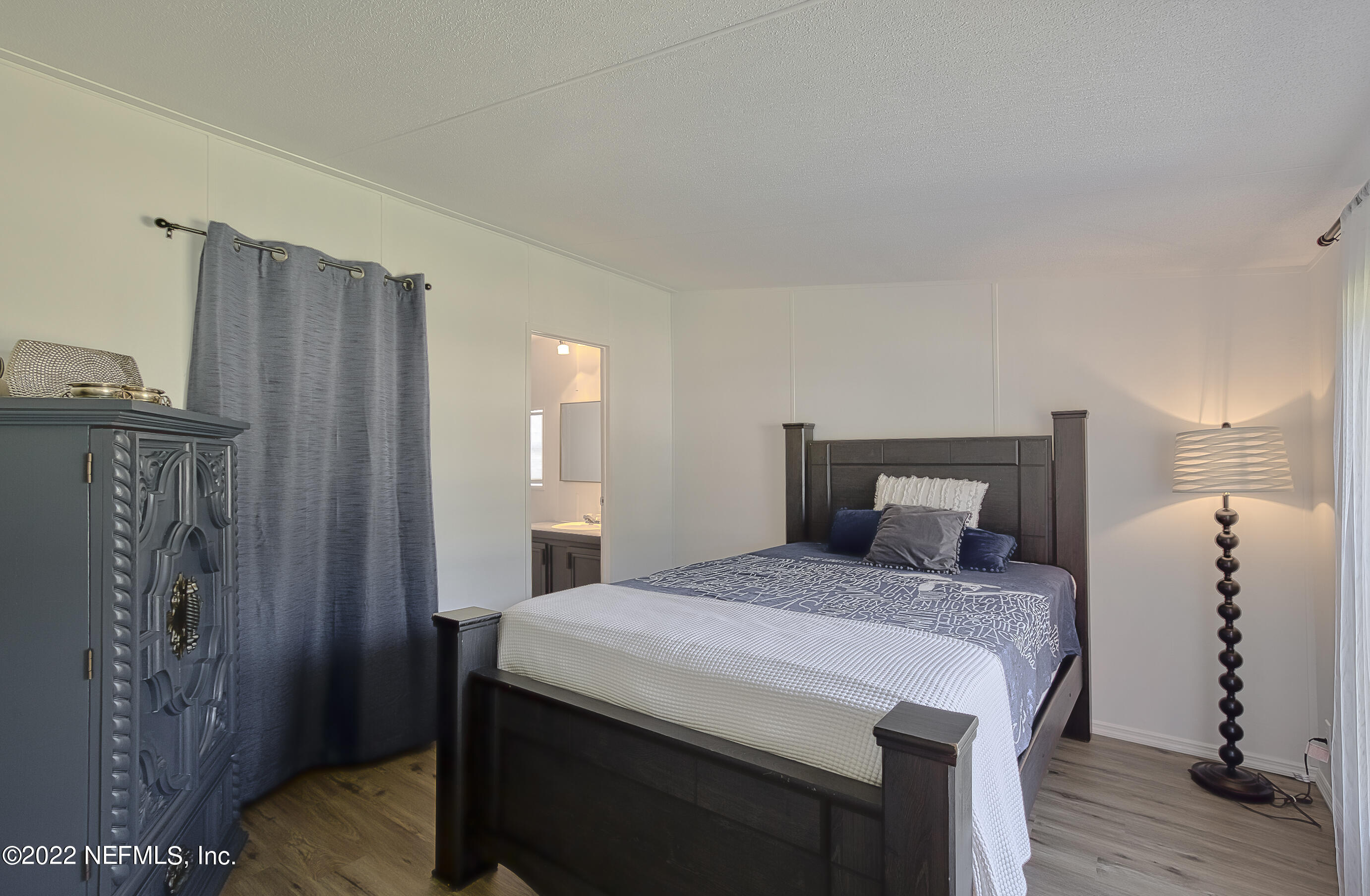 4509 De Leon Place St. Augustine, FL 32095 - Photo 17 of 35 a bedroom with a bed and wooden floor