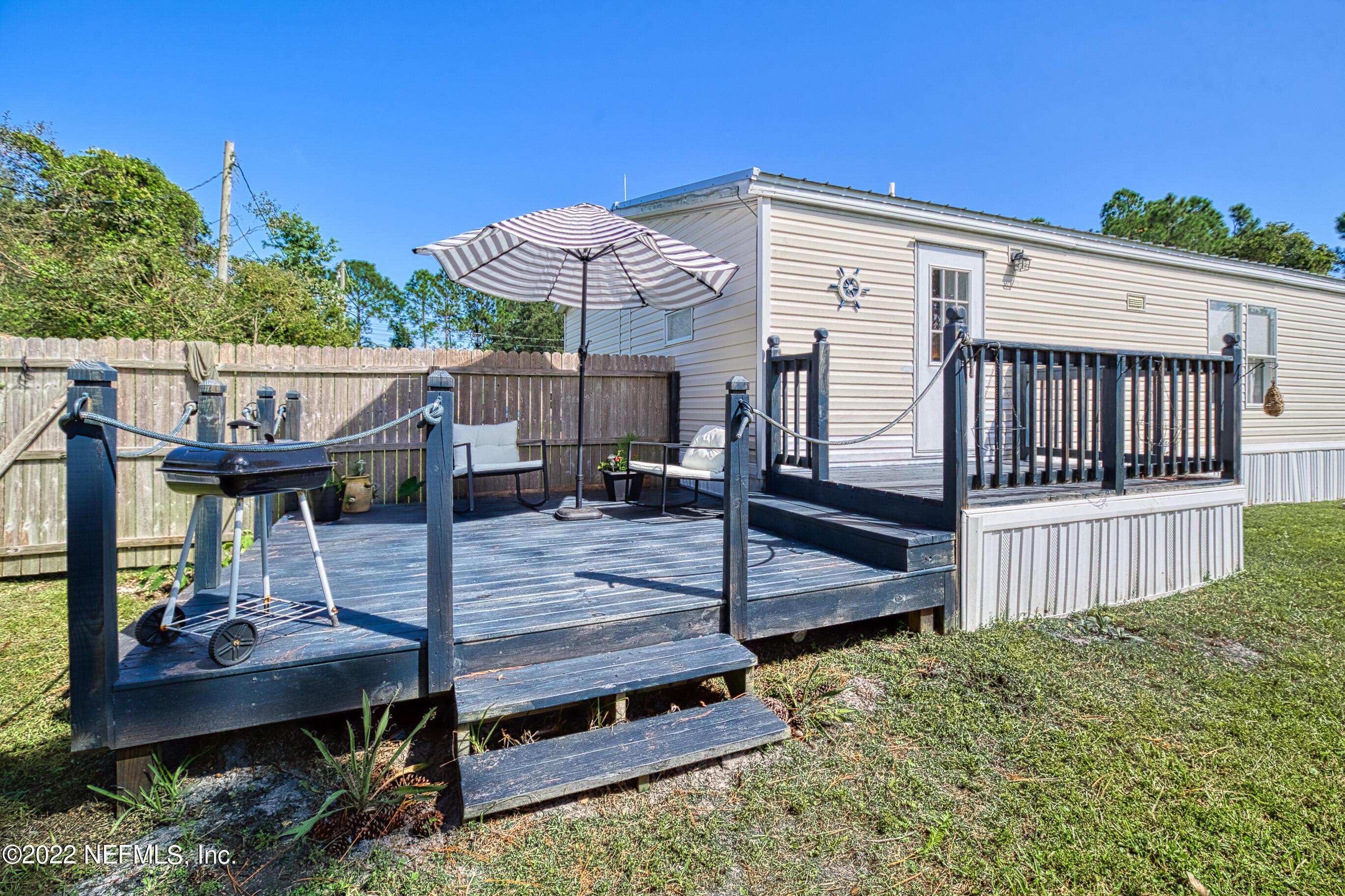 4509 De Leon Place St. Augustine, FL 32095 - Photo 24 of 35 a view of house with wooden deck and furniture