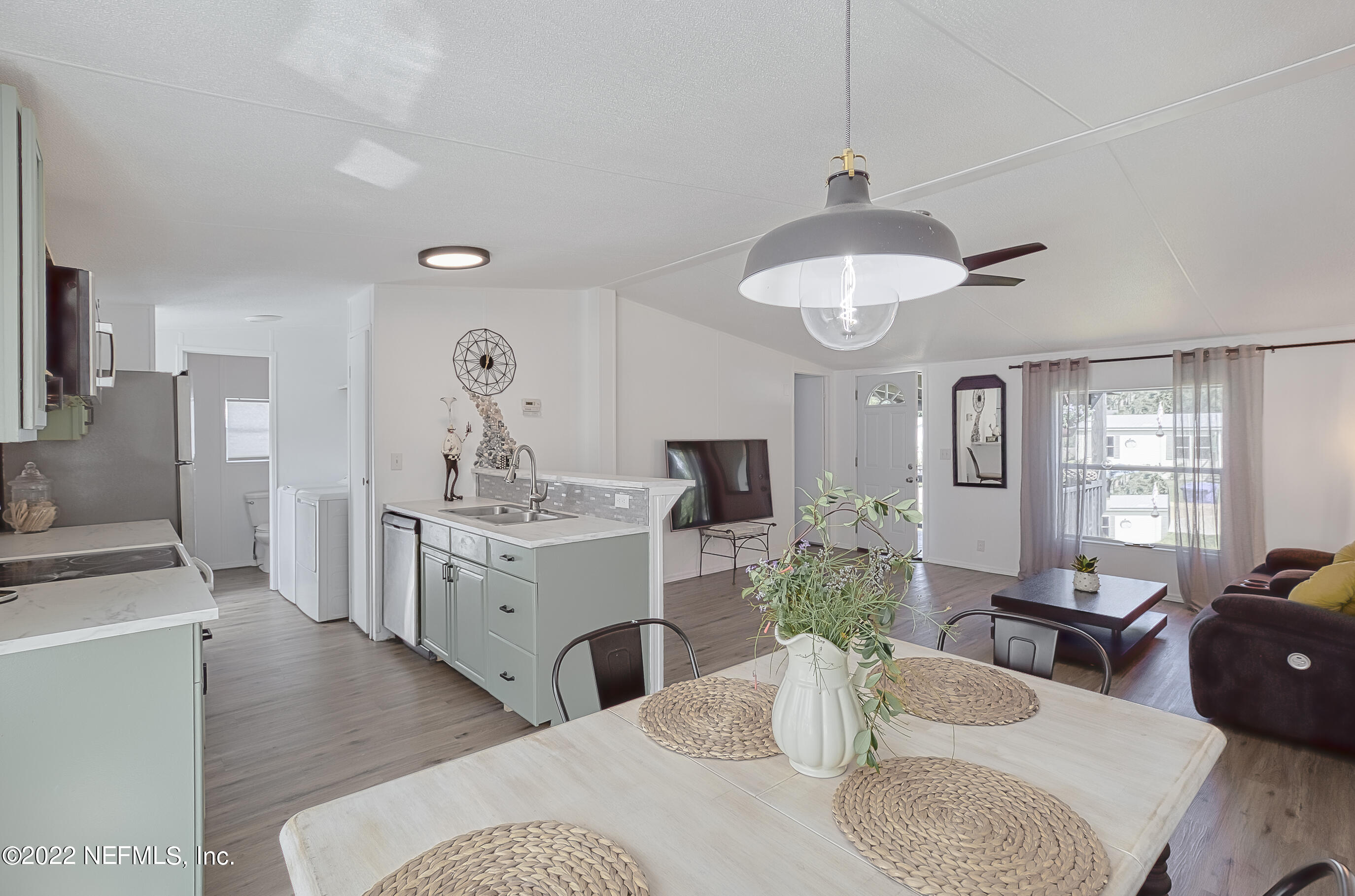 4509 De Leon Place St. Augustine, FL 32095 - Photo 3 of 35 a living room with furniture and a chandelier