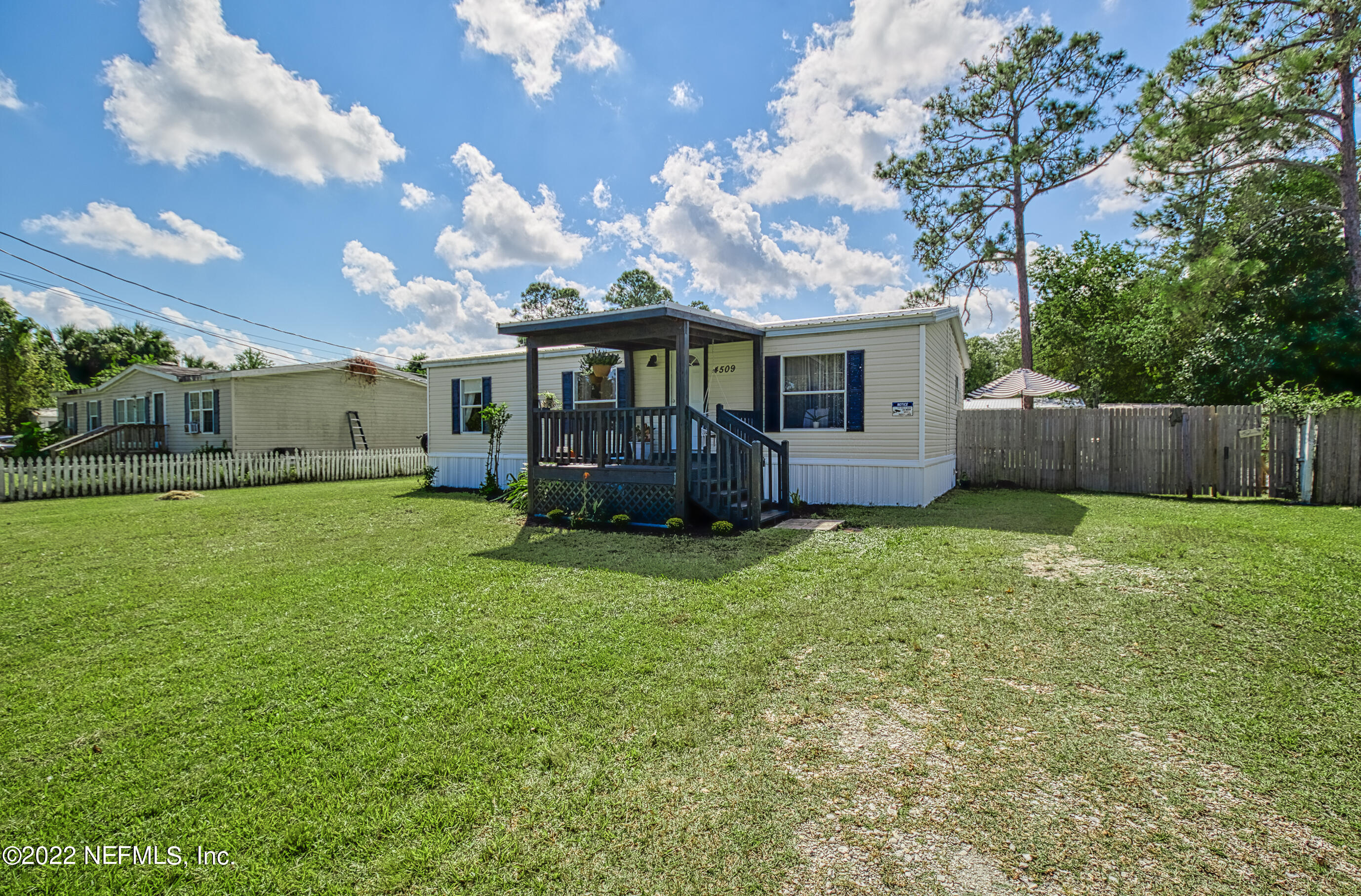 4509 De Leon Place St. Augustine, FL 32095 - Photo 34 of 35 a view of a house with backyard and a tree