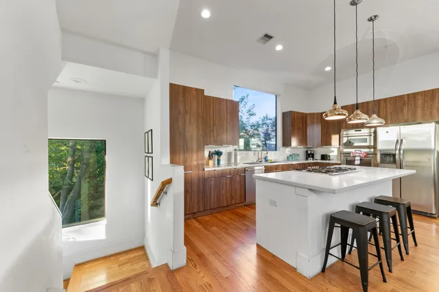 a kitchen with counter top space a sink appliances and cabinets