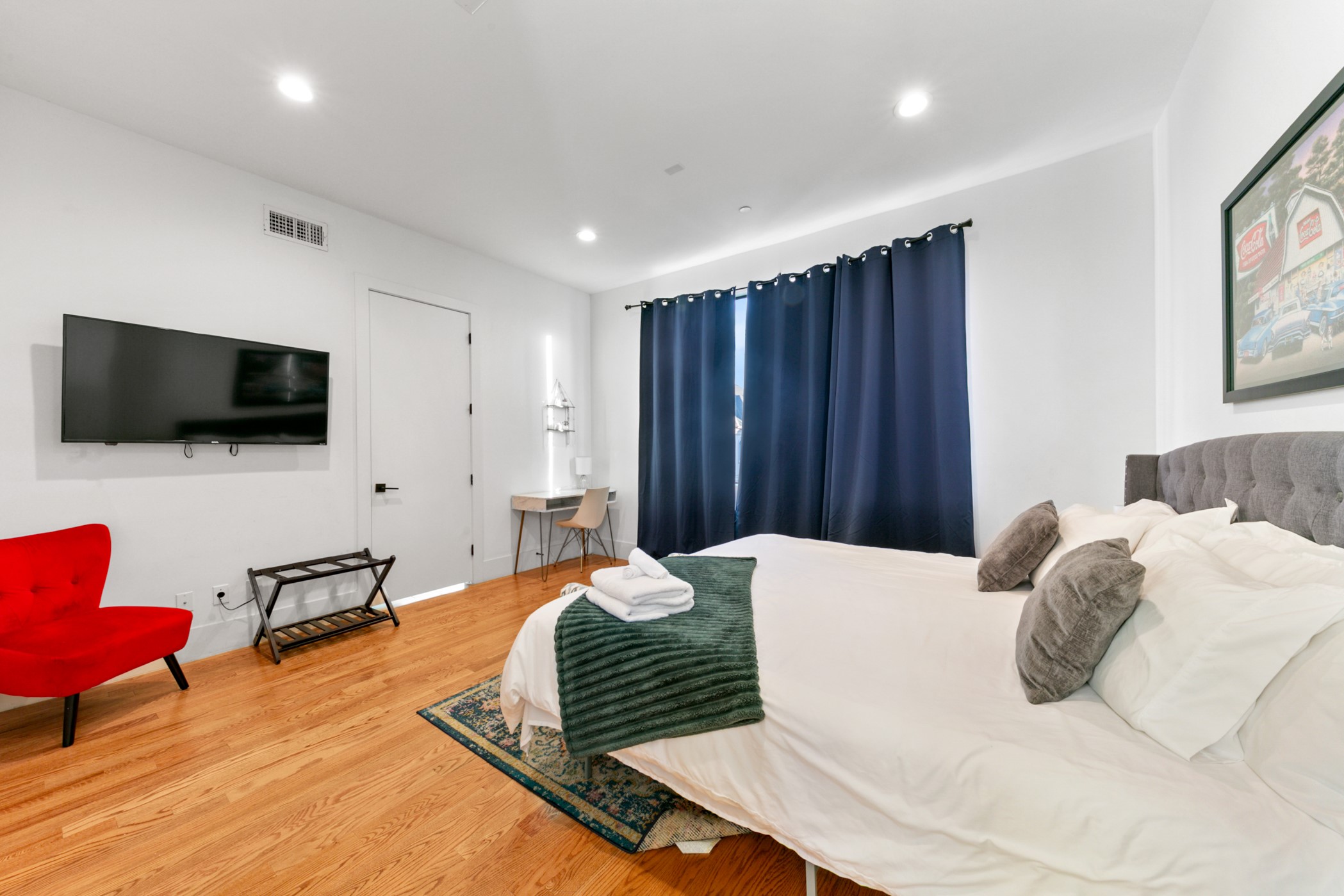 608 Oakley Street Houston, TX 77006 - Photo 21 of 37 a bedroom with a bed furniture and a flat screen tv
