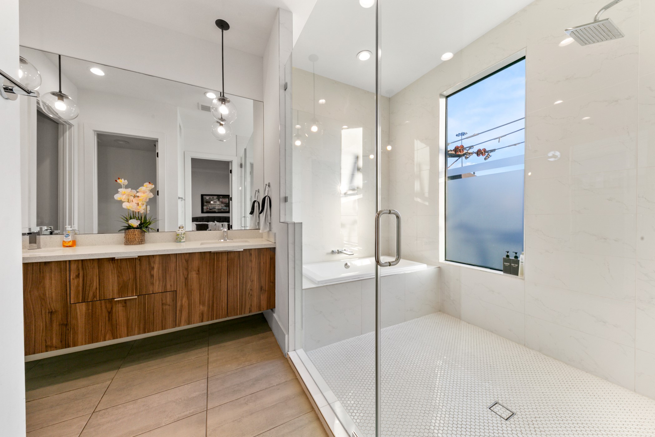 608 Oakley Street Houston, TX 77006 - Photo 23 of 37 a bathroom with a double vanity sink a toilet a mirror and shower