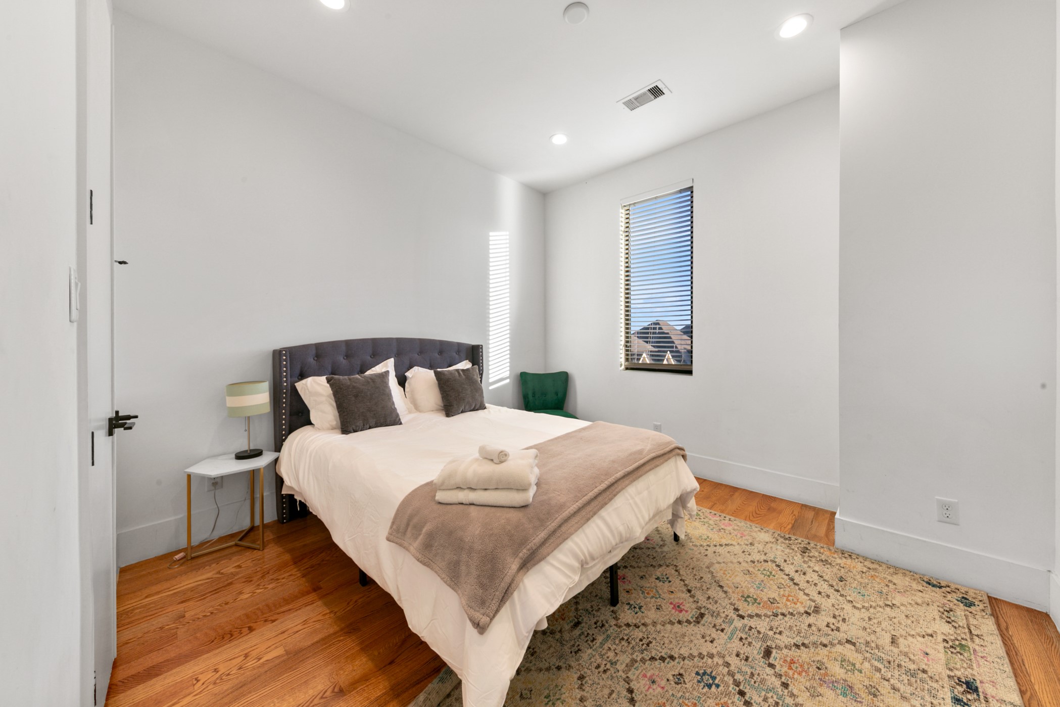 608 Oakley Street Houston, TX 77006 - Photo 28 of 37 a bedroom with bed and wooden floor