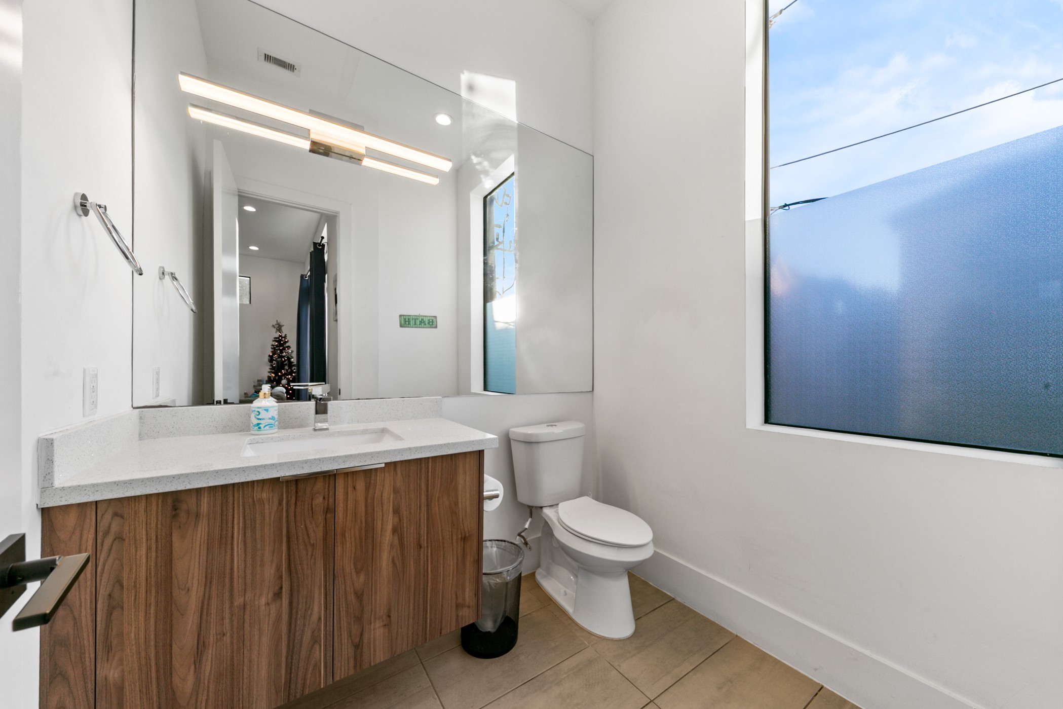 608 Oakley Street Houston, TX 77006 - Photo 10 of 37 a bathroom with a toilet sink vanity and mirror