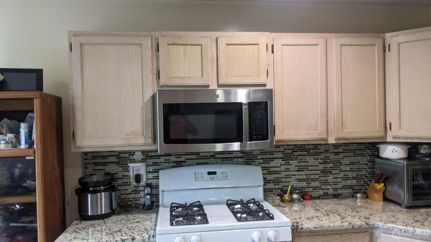 7 Newburgh Drive Edison, NJ 08820 - Photo 10 of 20 a kitchen with stainless steel appliances a stove a microwave and cabinets