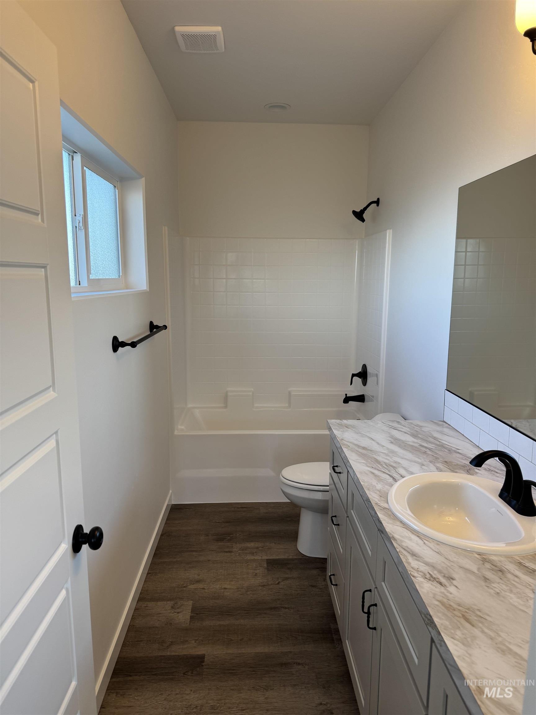 2008 Harrison Street South Twin Falls, ID 83301 - Photo 13 of 32 Bathroom featuring vanity, shower / bath combination, and dark wood-style floors