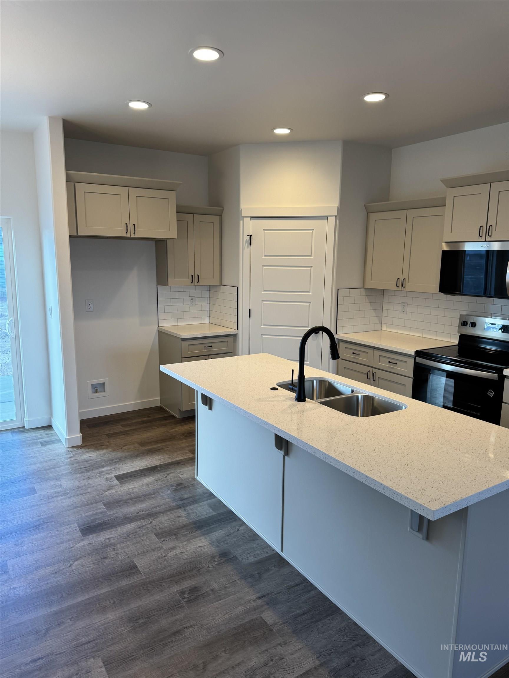2008 Harrison Street South Twin Falls, ID 83301 - Photo 3 of 32 Kitchen featuring stainless steel appliances, light stone countertops, tasteful backsplash, and recessed lighting