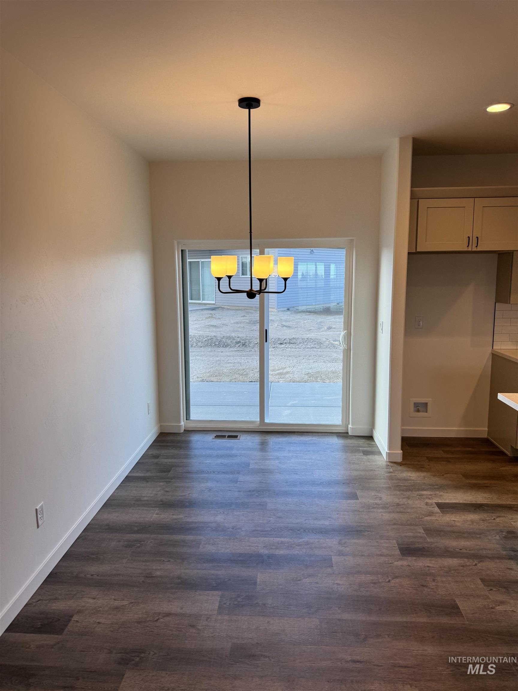 2008 Harrison Street South Twin Falls, ID 83301 - Photo 4 of 32 Unfurnished dining area featuring suspended lighting, dark wood-style floors, and healthy amount of natural light