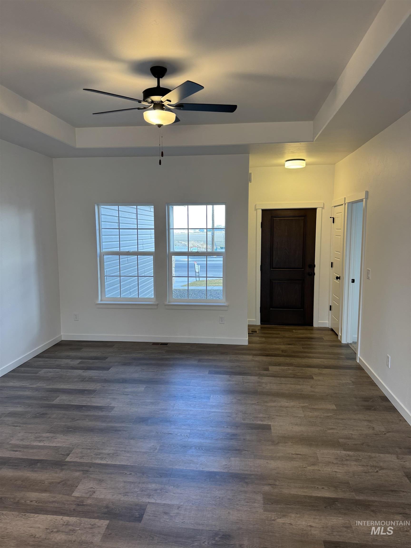 2008 Harrison Street South Twin Falls, ID 83301 - Photo 5 of 32 Foyer entrance with ceiling fan, a raised ceiling, and dark wood finished floors