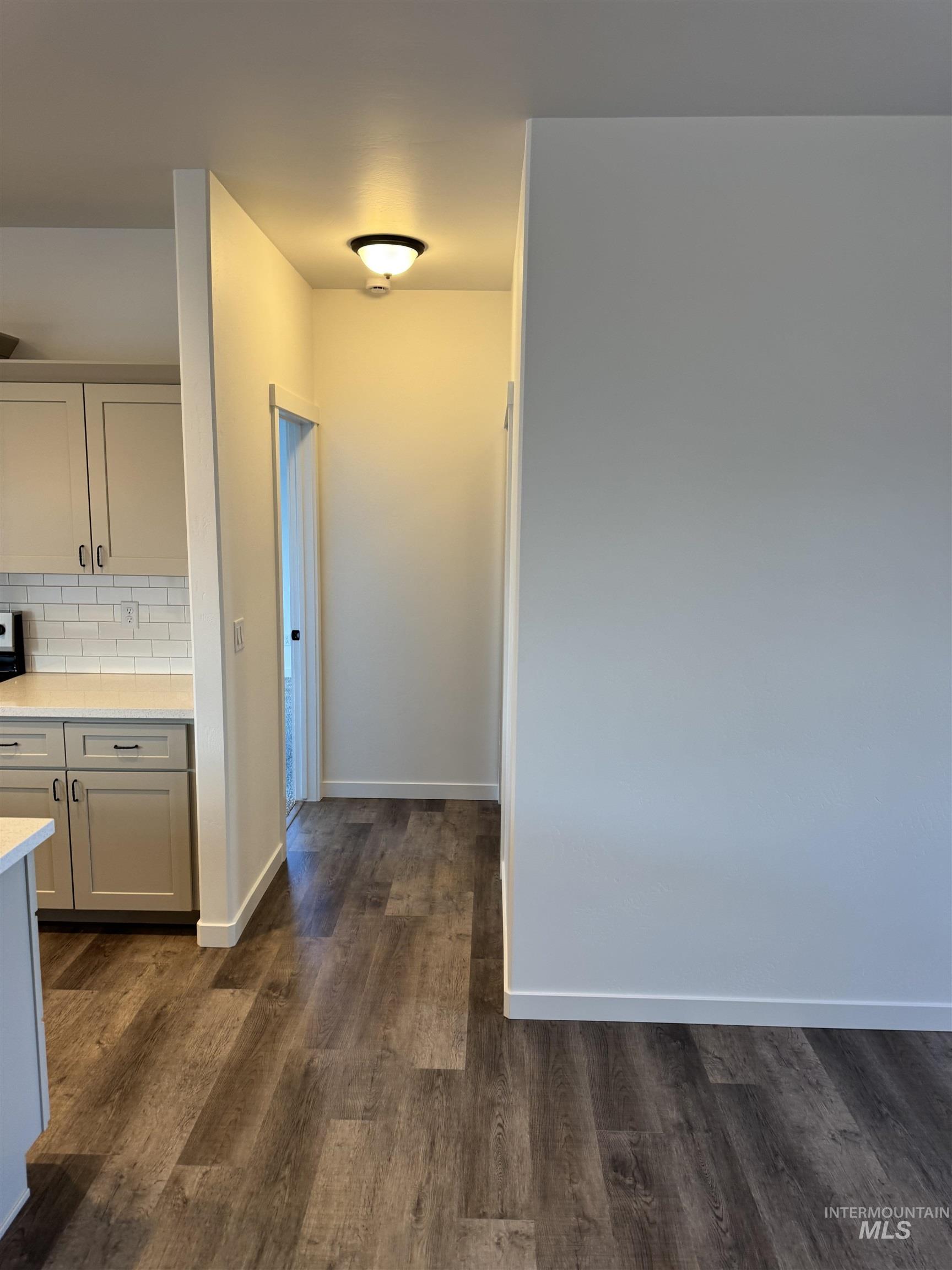 2008 Harrison Street South Twin Falls, ID 83301 - Photo 6 of 32 Hall with baseboards and dark wood-style floors