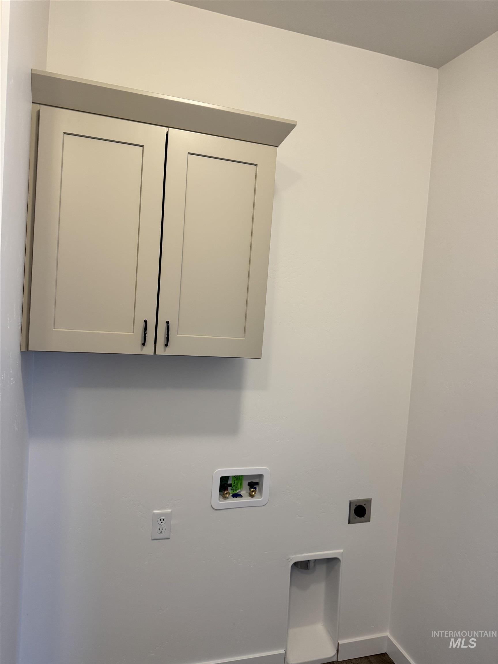 2008 Harrison Street South Twin Falls, ID 83301 - Photo 7 of 32 Laundry area featuring electric dryer hookup, cabinet space, and washer hookup