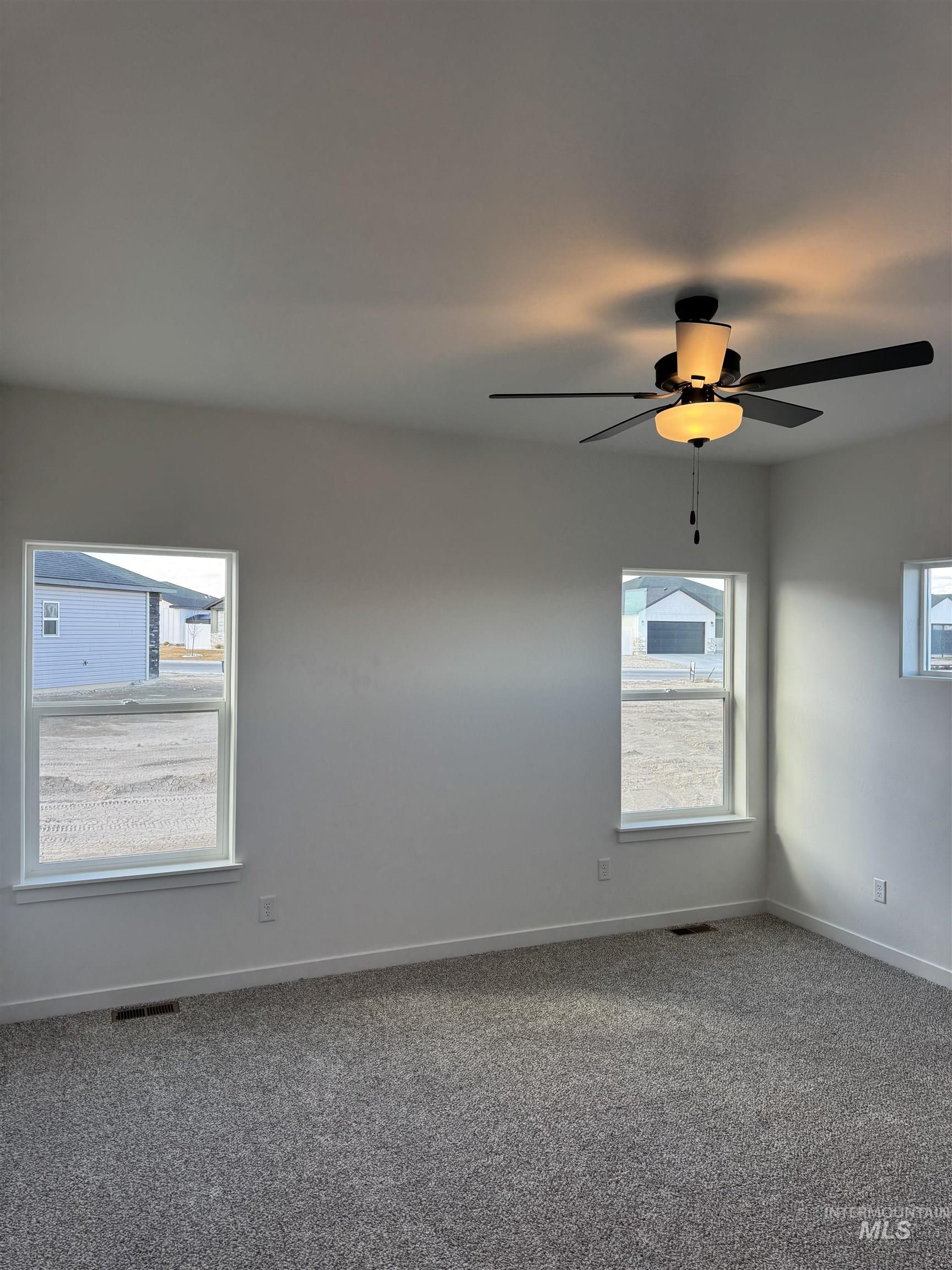 2008 Harrison Street South Twin Falls, ID 83301 - Photo 9 of 32 Carpeted spare room featuring a ceiling fan and baseboards