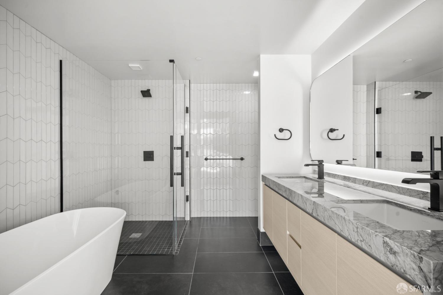 950 Tennessee Street, Unit 404 San Francisco, CA 94107 - Photo 23 of 80 a spacious bathroom with a granite countertop tub sink shower and mirror