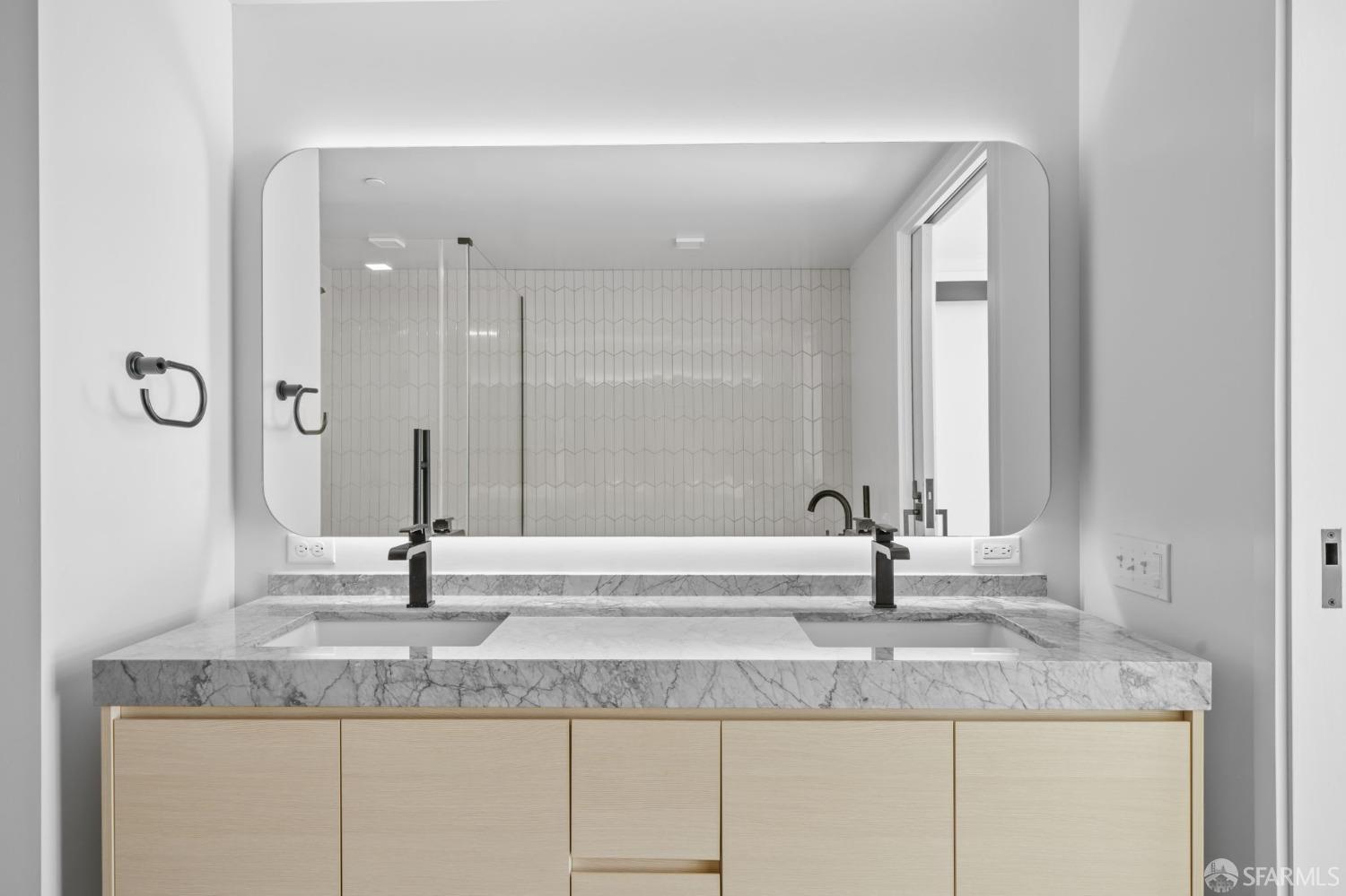 950 Tennessee Street, Unit 404 San Francisco, CA 94107 - Photo 24 of 80 a bathroom with a granite countertop sink and a mirror