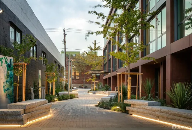 a lobby with furniture and potted plants
