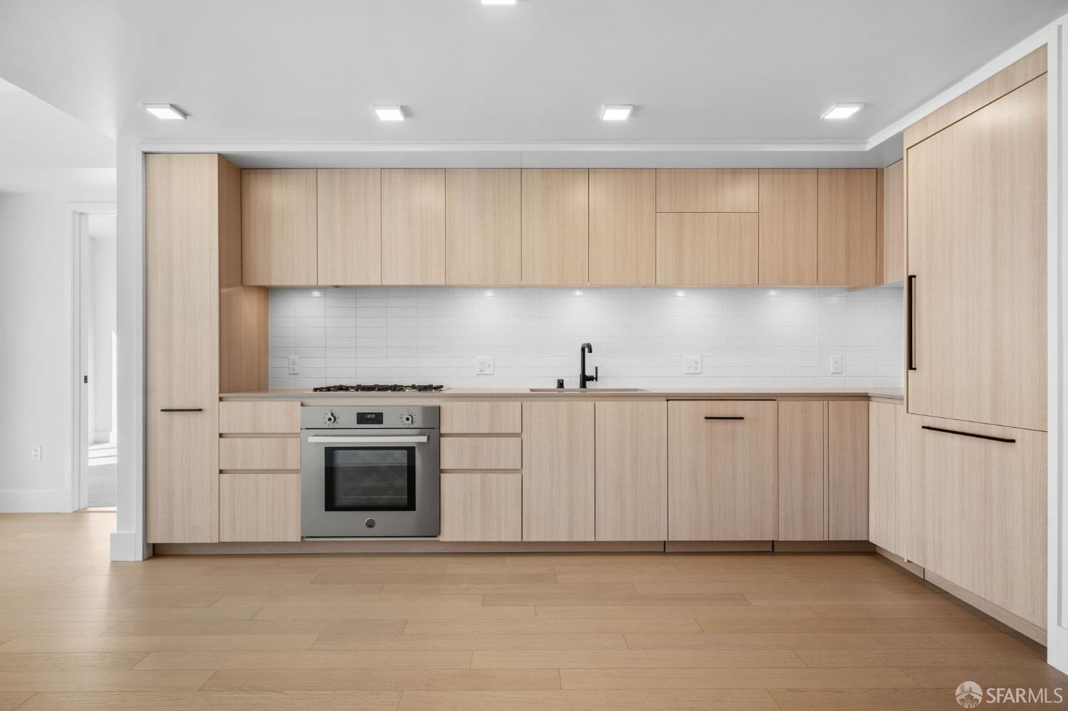 950 Tennessee Street, Unit 404 San Francisco, CA 94107 - Photo 6 of 80 a kitchen with white cabinets and white appliances