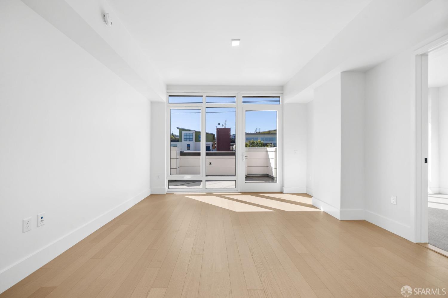 950 Tennessee Street, Unit 404 San Francisco, CA 94107 - Photo 7 of 80 a view of empty room with kitchen and windows