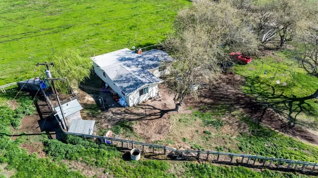 an aerial view of a house with a yard