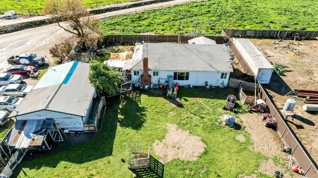 an aerial view of a house with swimming pool garden and patio