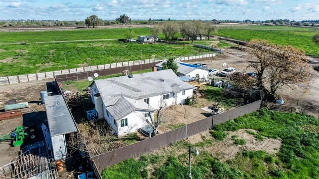 an aerial view of a house with outdoor space