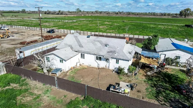an aerial view of a house with garden space and outdoor seating