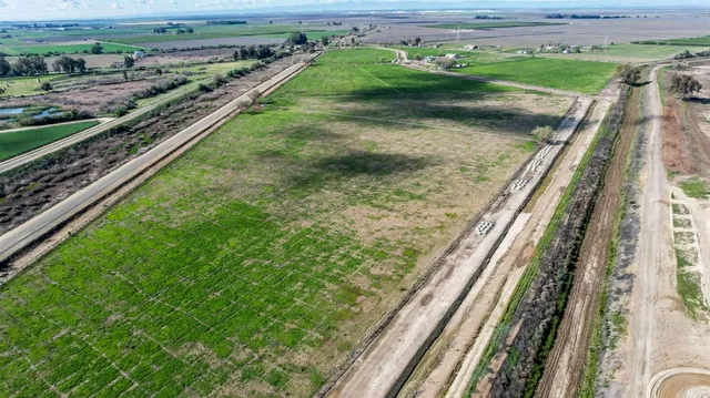 a view of a yard with wooden fence