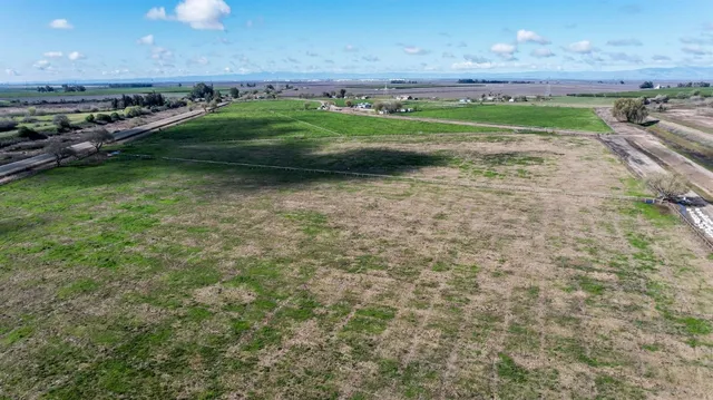 a view of a field with an trees