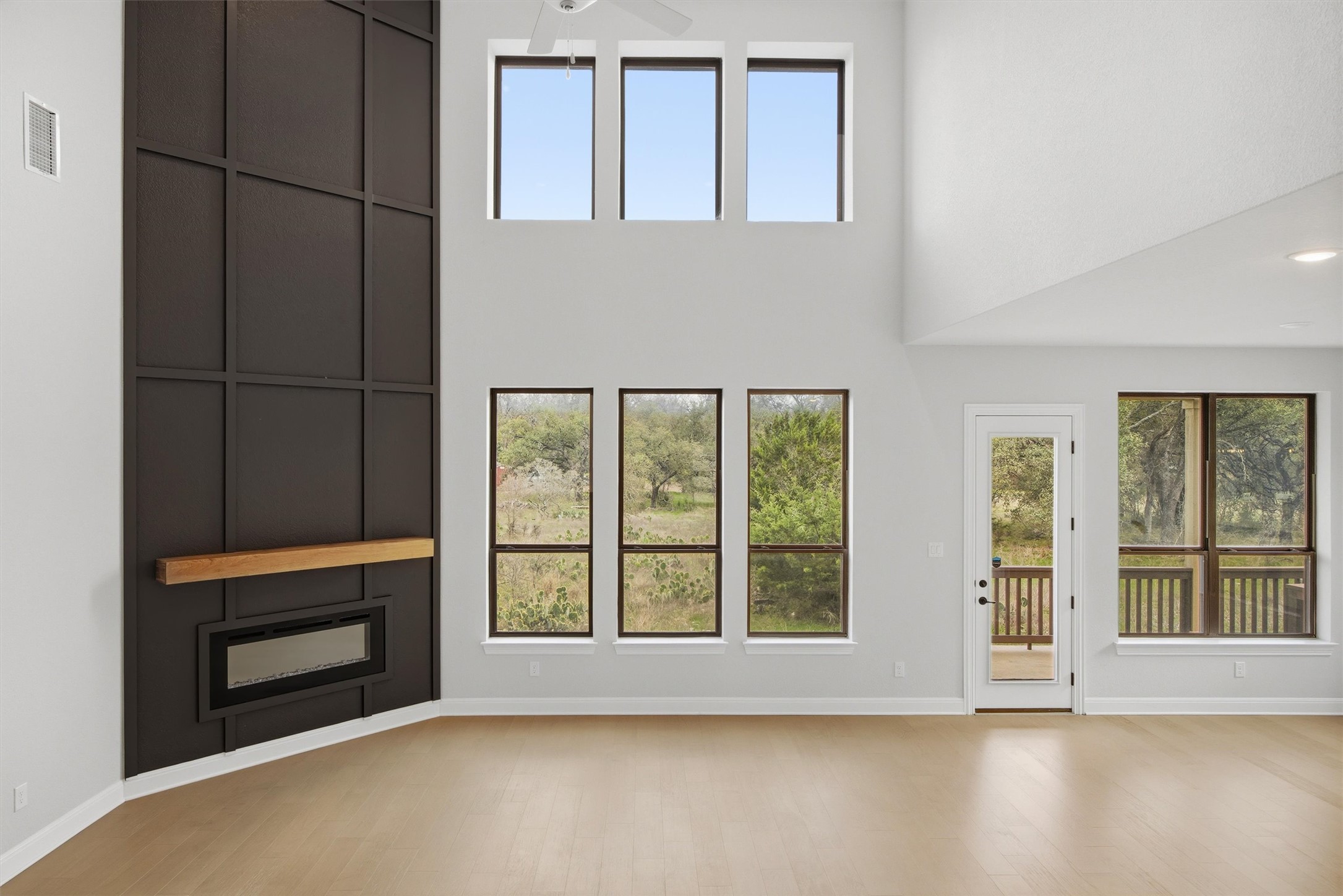 208 Tovas Secret Cove Georgetown, TX 78628 - Photo 12 of 40 an empty room with wooden floor and windows