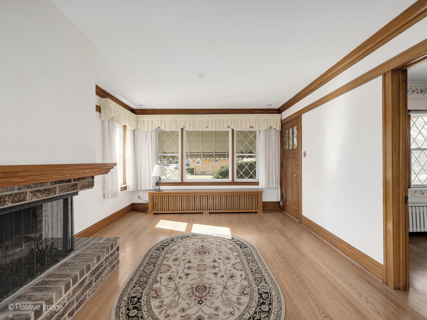 2435 Keystone Avenue North Riverside, IL 60546 - Photo 8 of 27 a living room with a couch wooden floor and a fireplace