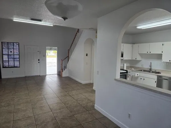 a kitchen with stainless steel appliances a stove a sink a refrigerator and cabinets