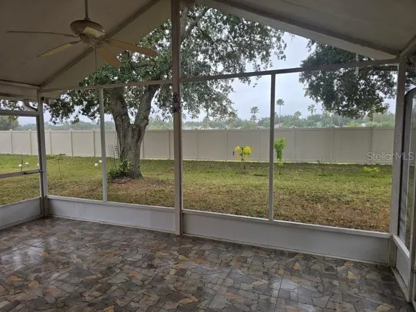 a view of a yard with a tree in the background